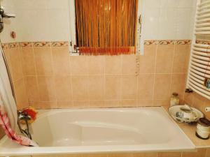 a bath tub in a bathroom with a window at Maison cooconing in Sumène +12 photos