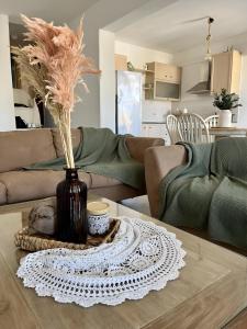 a living room with a table with a vase with feathers at seaview Foinikas in Finikas
