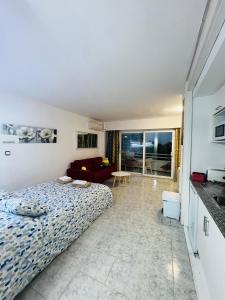 a bedroom with a bed and a living room at Apartamento Laura in Alcudia