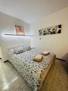a bedroom with a bed with two towels on it at Apartamento Laura in Alcudia +19 photos