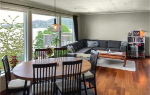 a living room with a table and a couch at Awesome Home In Vgstranda With Wifi in Hjelvik