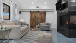 a living room with a couch and a fireplace at An Enchanted Hideaway outdoor fireplace hot tub in Fredericksburg