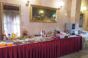 a table with many plates of food on it at Bed & Breakfast Palma Medulin in Medulin