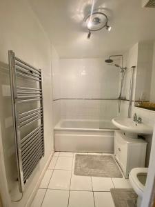 a white bathroom with a tub and a sink at Holliday Street Apartments - One Bedroom - Stunning Balcony in Birmingham