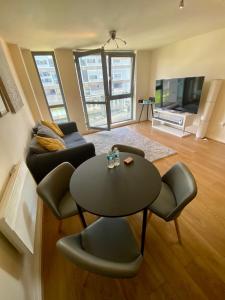 a living room with a table and a couch at Holliday Street Apartments - One Bedroom - Stunning Balcony in Birmingham