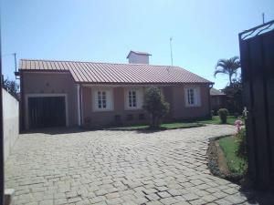 a brick driveway in front of a house at Villa Herifanja Antsirabe in Antsirabe