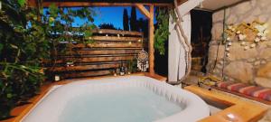 a white bath tub sitting in a yard at Taverna -Sunce- with jacuzzi in Vis