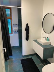 a bathroom with a sink and a mirror at STAY Billund in Vandel