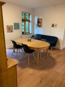 a living room with a table and chairs and a couch at STAY Billund in Vandel