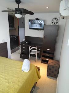 a bedroom with a bed and a desk and a tv at R.1105 Estudio Ejecutivo, céntrico y funcional. in Panama City