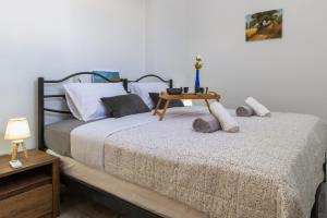 a bedroom with a bed with a table on it at (Stoa escape) traditional home in Archangelos