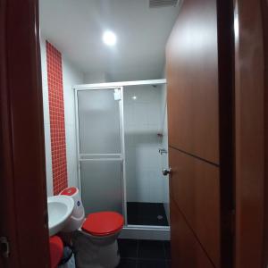 a bathroom with a shower and a toilet and a sink at HOTEL PLAZA 6 in Sogamoso