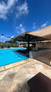 a large swimming pool next to a building at Pé na Areia no Cumbuco - Eco Paradise 110 in Caucaia