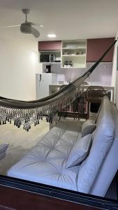 a bed in a living room with a hammock at Eco Paradise 110 - Cumbuco in Caucaia