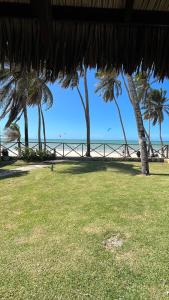 a view of a beach with palm trees and the ocean at Eco Paradise 110 - Cumbuco in Caucaia