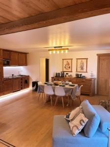 a living room with a blue couch and a table at Il Focolare - Attico centrale di charme in Sauze dʼOulx