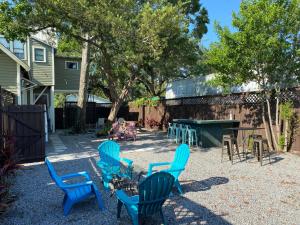 a group of blue chairs and tables in a yard at The Contemporary in Sanford