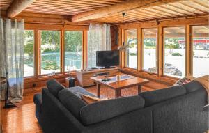 a living room with a couch and a table at 3 Bedroom Lovely Home In Arboga in Arboga