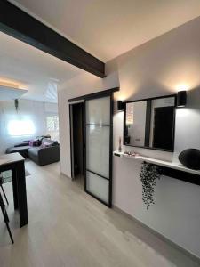 a living room with a couch and a television on a wall at Apartamento marqués in Madrid