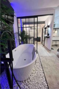 a large white bath tub sitting in a room at Apartamento marqués in Madrid