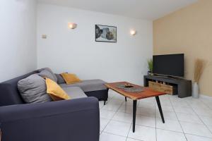 a living room with a couch and a coffee table at Apartments with parking space Brsec, Opatija - 7755 in Brseč