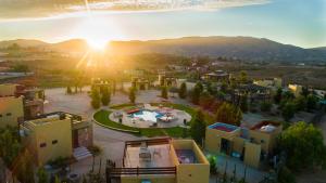 an aerial view of a resort with the sun setting at Cuatro Lunas Hotel Boutique in Valle de Guadalupe