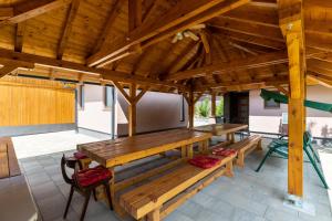 a large wooden pavilion with benches on a patio at Apartments for families with children Karlovac - 20989 in Karlovac