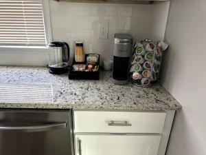 a kitchen counter with a coffee maker on a counter top at Stylish, Relaxing & Comfy 3 BDR Home in Bristol
