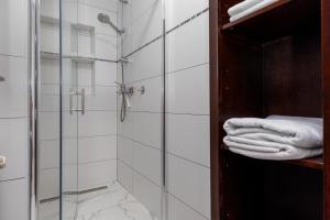 a bathroom with a glass shower stall with towels at Apartments for families with children Karlovac - 20989 in Karlovac +17 photos