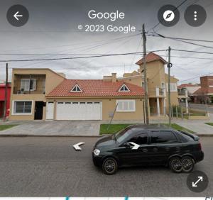 a black car parked in front of a house at Departamento Residencial in San Fernando del Valle de Catamarca