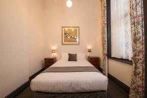 Postel nebo postele na pokoji v ubytování Vue Grand Hotel