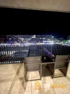 a table and two chairs in a room with a view at Braddon 1BD - Walk to Cafés, Secure Parking in Canberra