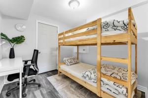 a bedroom with two bunk beds and a desk at Oshawa Family Haven - Luxury 7BR Villa with Cozy Fireplaces & Hot Tub in Oshawa