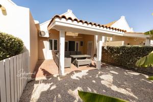 a patio of a house with a white fence at Dushi Townhouse Curaçao in Willemstad
