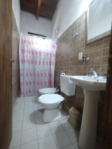 a bathroom with a toilet and a sink at La Casa de la Abuela Tilcara in Tilcara