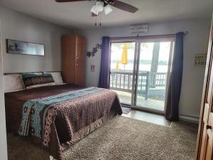 a bedroom with a bed and a window with a balcony at Caribbean Club Resort in Wisconsin Dells