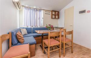 ein Wohnzimmer mit einem blauen Sofa und einem Tisch in der Unterkunft Beautiful Home In Turanj With Wifi in Turanj