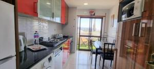 a kitchen with a sink and a counter top at Sunshine Apartment Alvor in Alvor