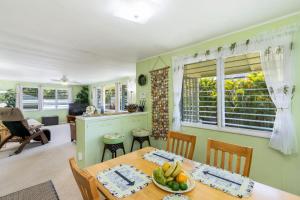 a kitchen and dining room with a table and chairs at Last Minute Deal! Stunning 2-Bedroom Beachfront House with AC in Kailua