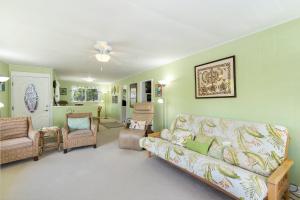 a living room with a couch and chairs at Last Minute Deal! Stunning 2-Bedroom Beachfront House with AC in Kailua
