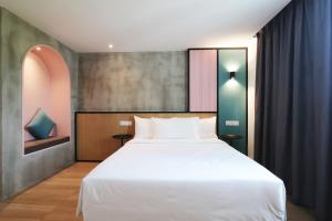 a bedroom with a large white bed in a room at The Bayou Hotel Langkawi in Pantai Cenang