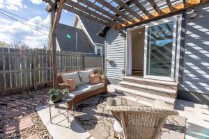 a patio with a couch and a table at Luxurious Historic Renovated Bungalow DT Rapid City with Private Patio in Rapid City