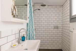 a white bathroom with a sink and a shower at Swift View in Skopelos Town +24 photos