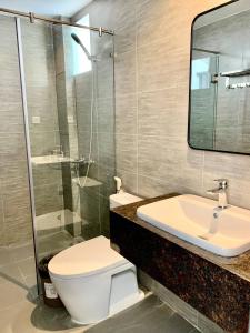 a bathroom with a toilet and a sink and a mirror at Luu Gia Hotel in Nha Trang