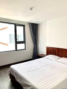 Postel nebo postele na pokoji v ubytování Luu Gia Hotel