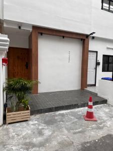 a traffic cone sitting in front of a building at Dado9home in Khlong Toei