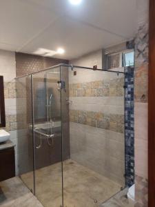 a shower with a glass door in a bathroom at Lucky Beach Resort in Trincomalee