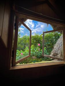 an open window with a view of pink flowers at Vườn Nhà Củi in Da Lat