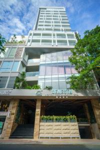 a tall white building with a staircase in front of it at Seaesta Nha Trang Hotel in Nha Trang