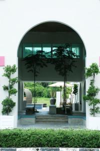 an archway with two trees in a building at The Bayou Hotel Langkawi in Pantai Cenang